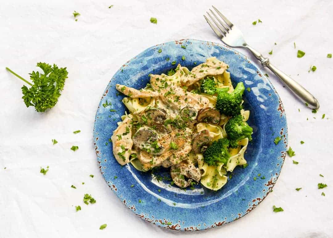 A plate of pasta with broccoli