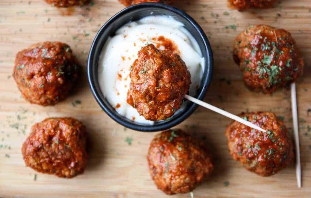 A bowl of dip with meatballs