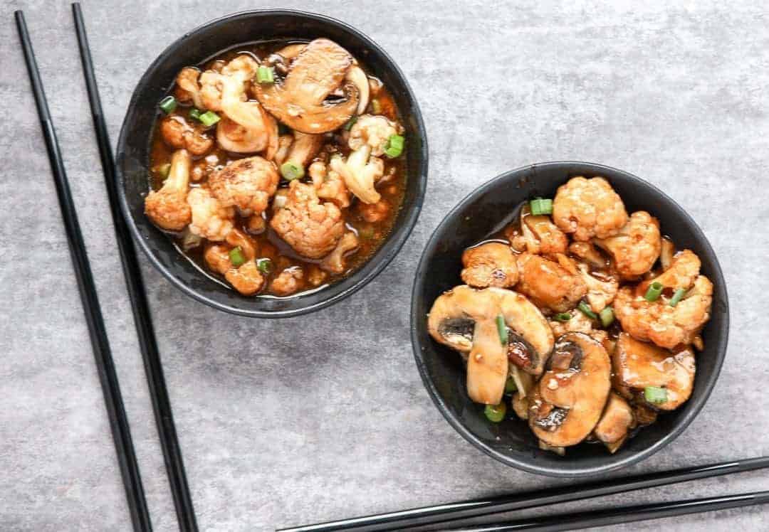 Two bowls of Mushrooms and cauliflower in sauce