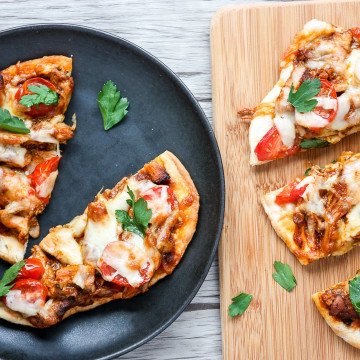 A slice of pizza sitting on top of a wooden table