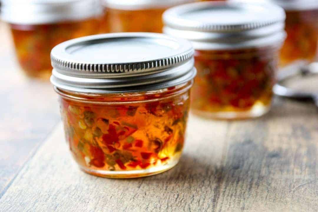 A close up of a jar of jelly on a counter