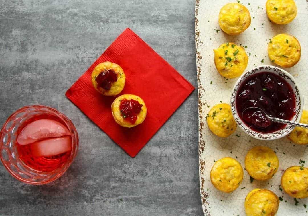 Mini Quiche Appetizers with Cranberry Sauce and a holiday beverage