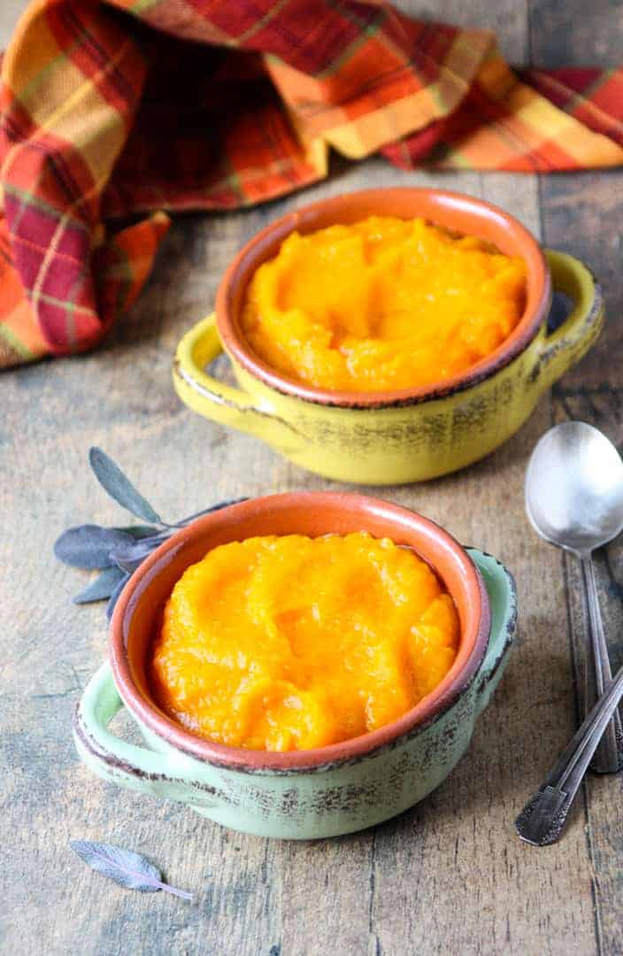 A bowl of food on a table, with Butternut squash