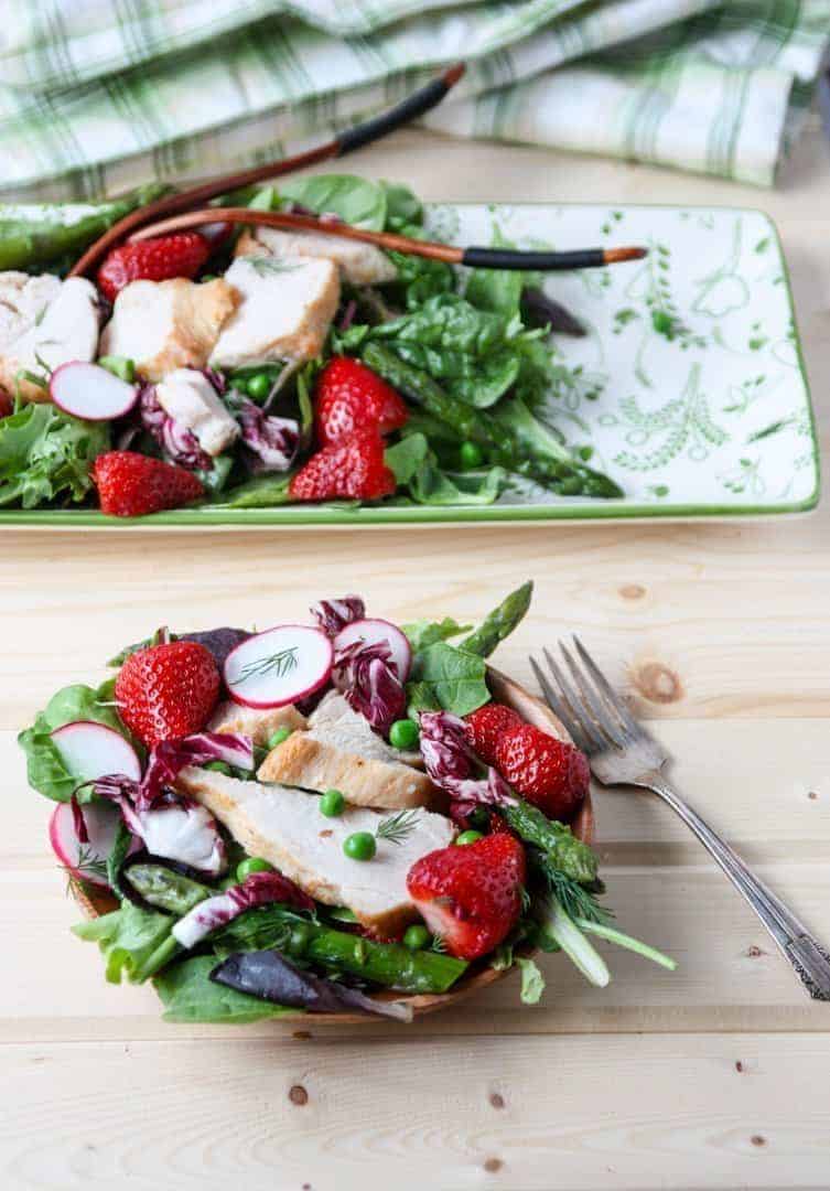 Platter of salad with chicken and one individual plate