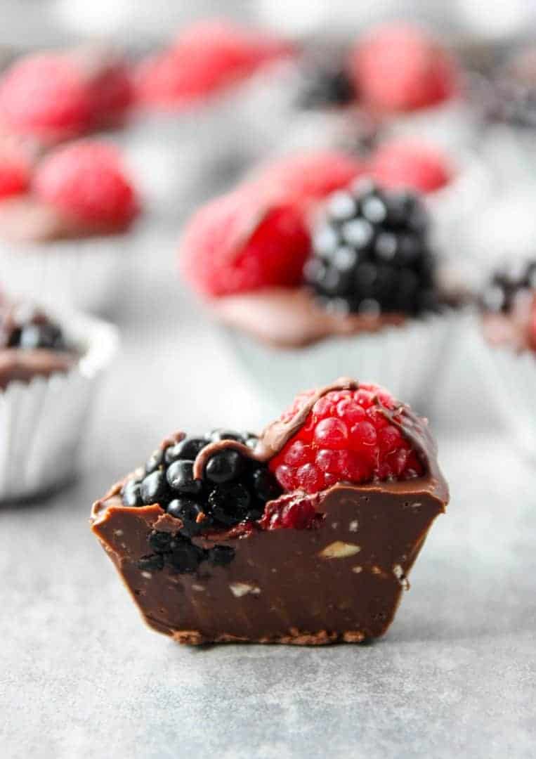 chocolate berry cup cut in half to show berries and nuts inside.