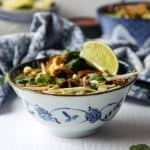 blue & white asian style bowl of vegan pho soup with lime & cilantro