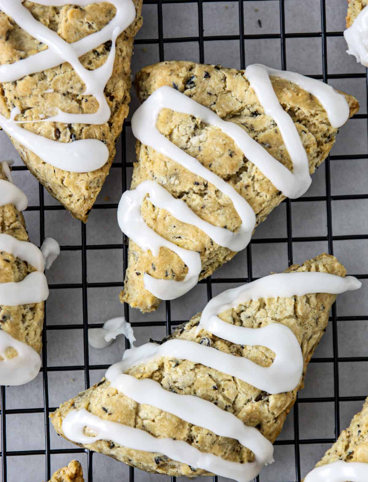 Glazed Earl Grey scones on a wire rack.