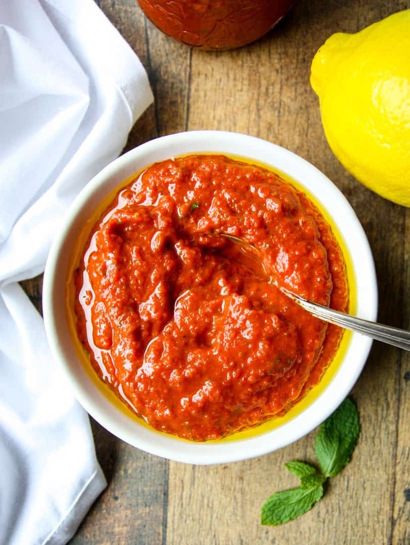 Harissa Paste in a white bowl with a spoon
