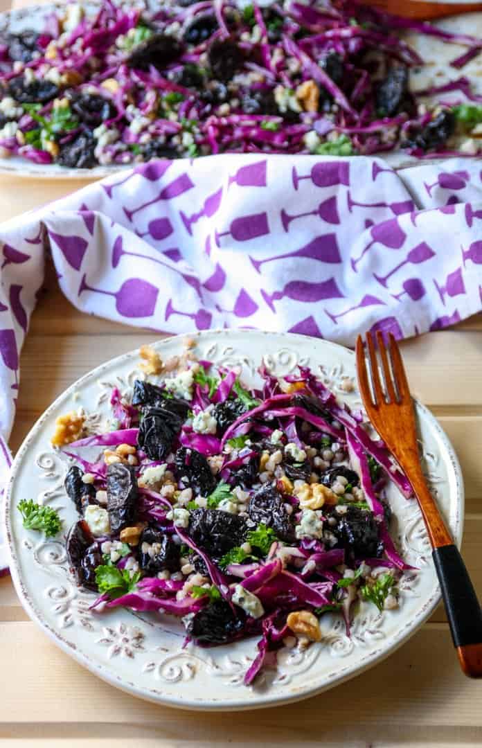 A plate of food on a table, with Prunes and Salad