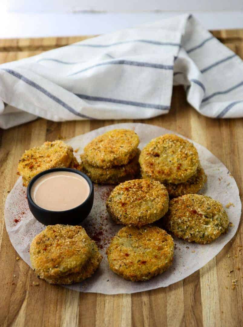 Oven Fried Green Tomatoes on parchment on a wooden table