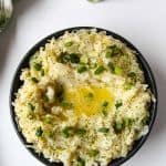 Irish Mashed Potatoes in a black dish on a white table.
