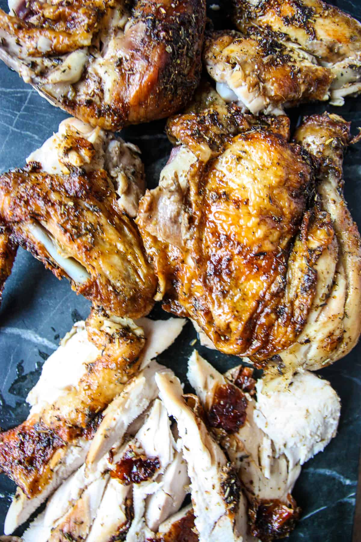 Carved chicken pieces on a marble board..