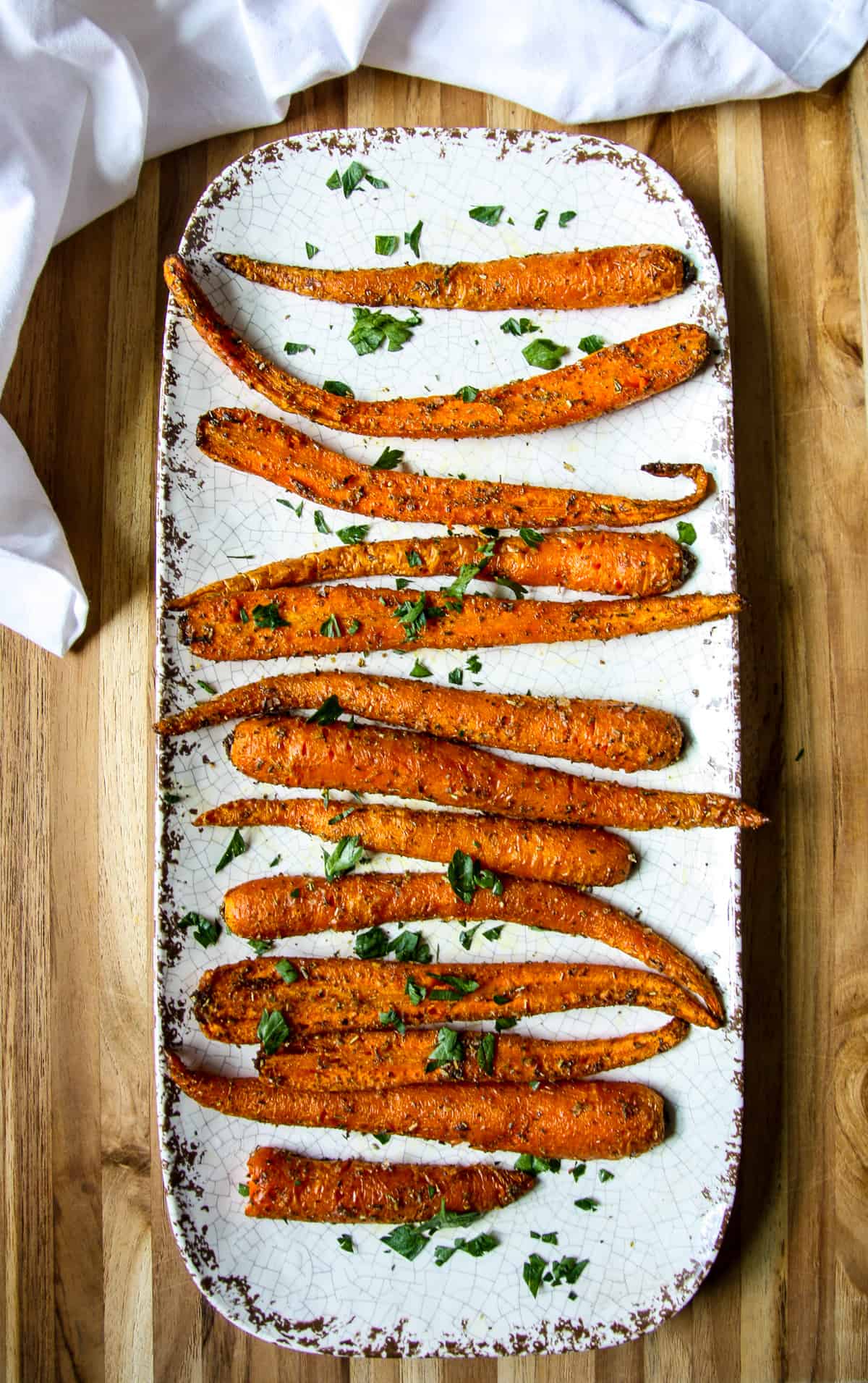 Air fried carrots on white plate.
