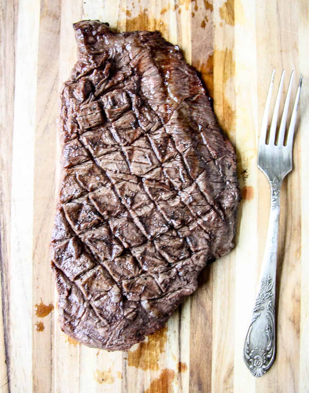 An Air Fryer Flank Steak cooked and ready to be sliced.