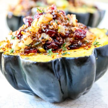 Two stuffed air fried acorn squash halves.