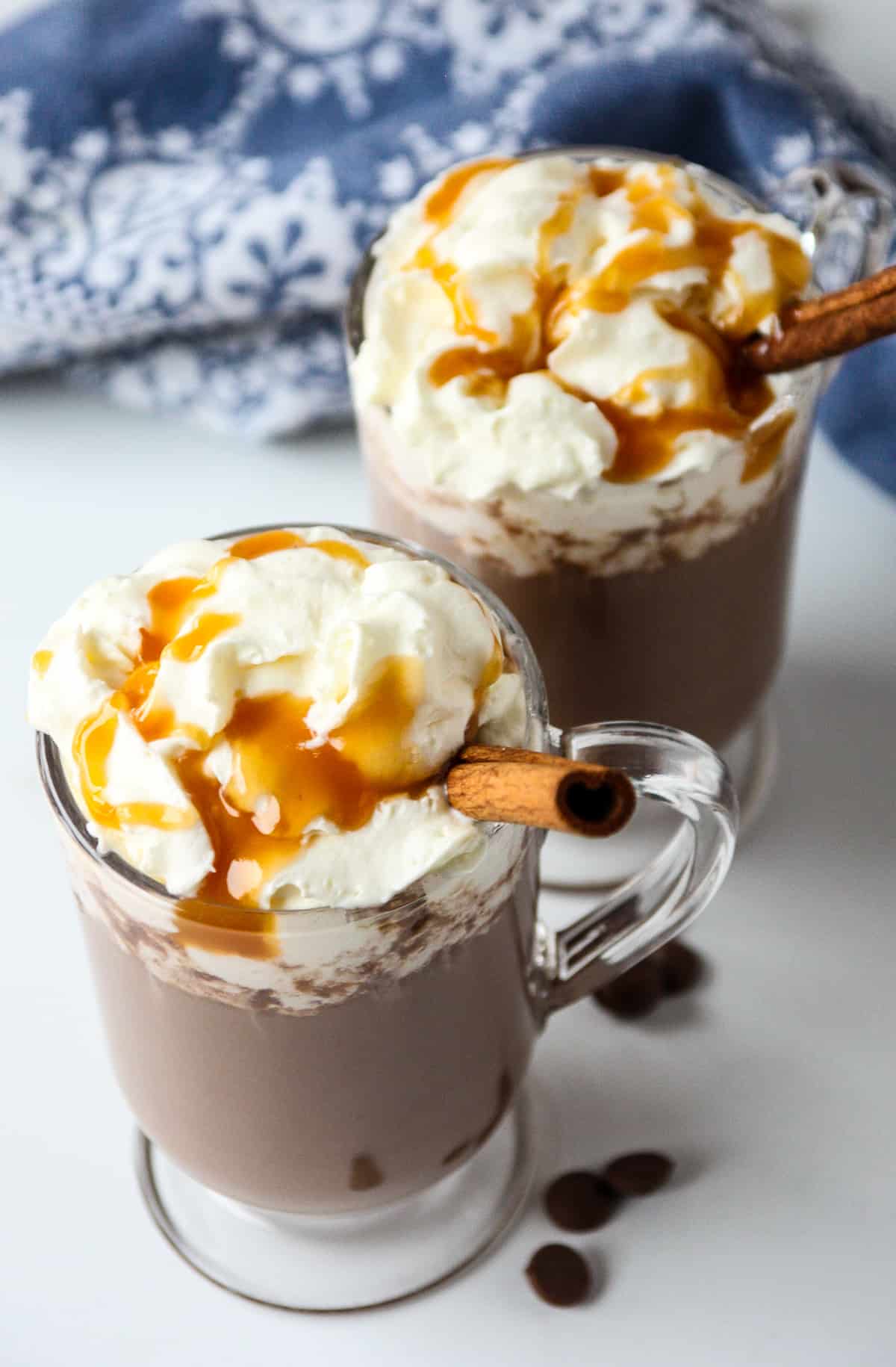 Two Rumchata hot chocolate drinks in glass mugs.