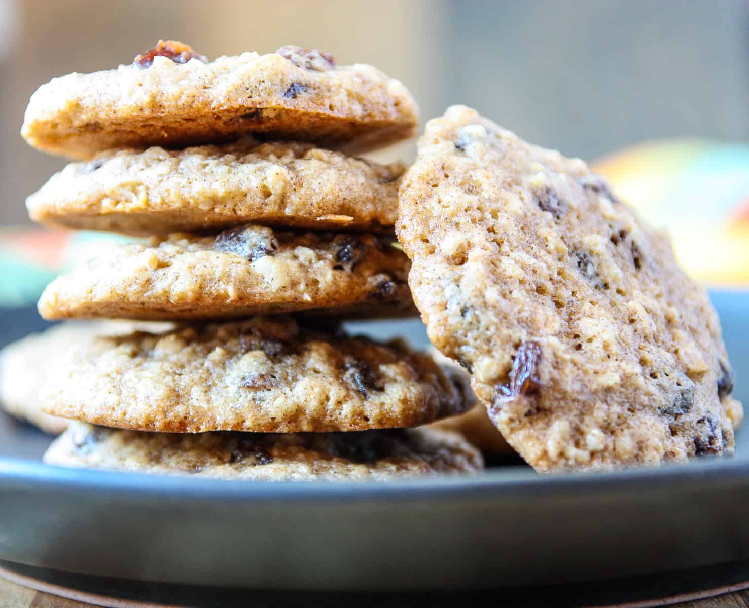 A stack of cookies on a black plate.