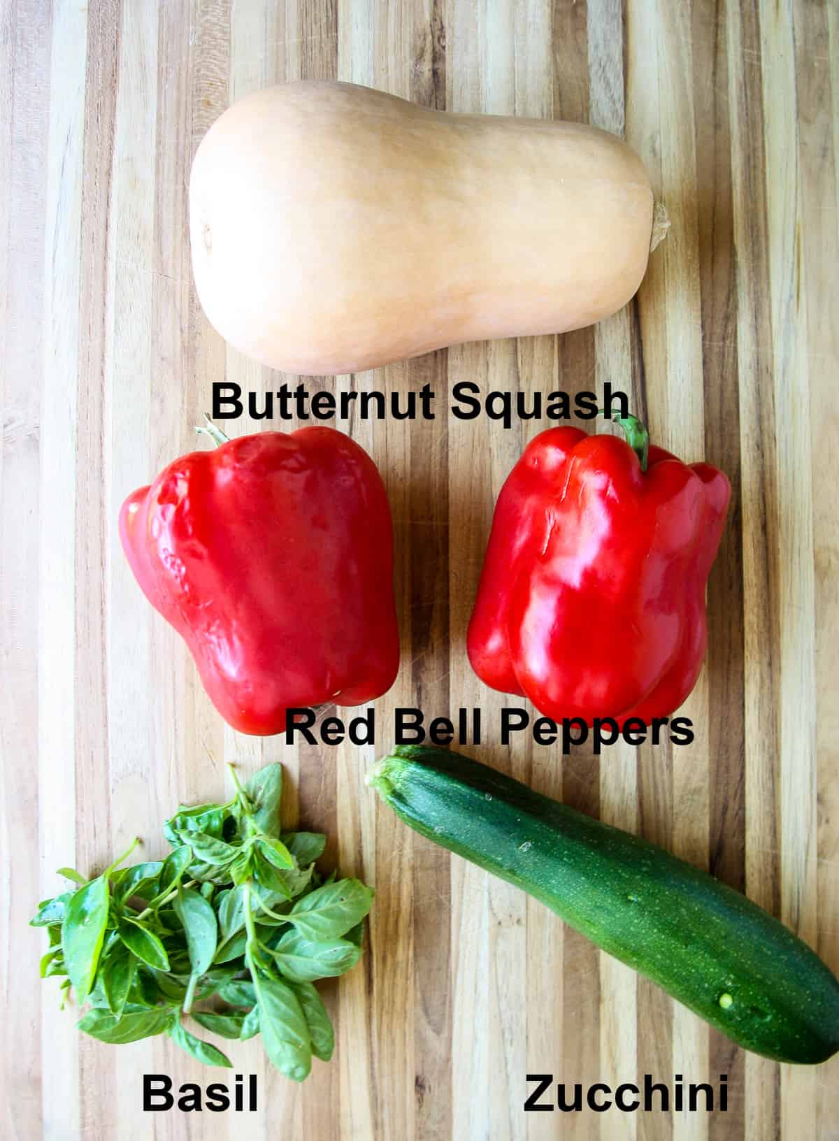 The vegetables that go into this lasagna recipe on a wooden board.