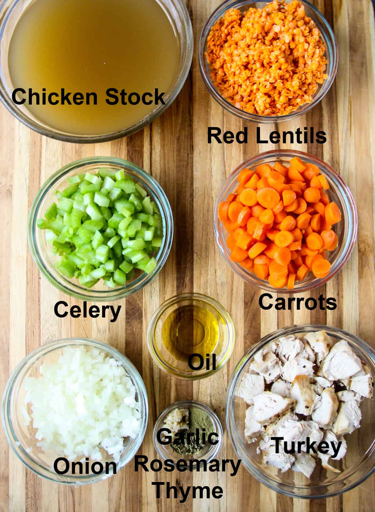 All of the ingredients needed to make this recipe in glass bowls on a wooden board.
