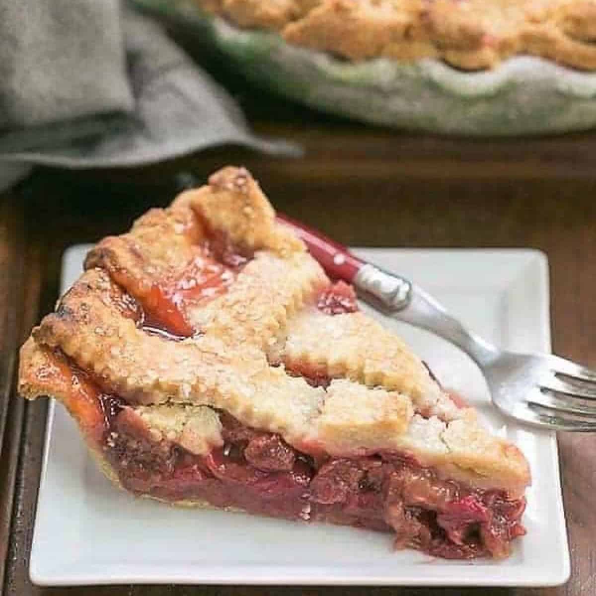 A slice of rhubarb pie on a white plate.