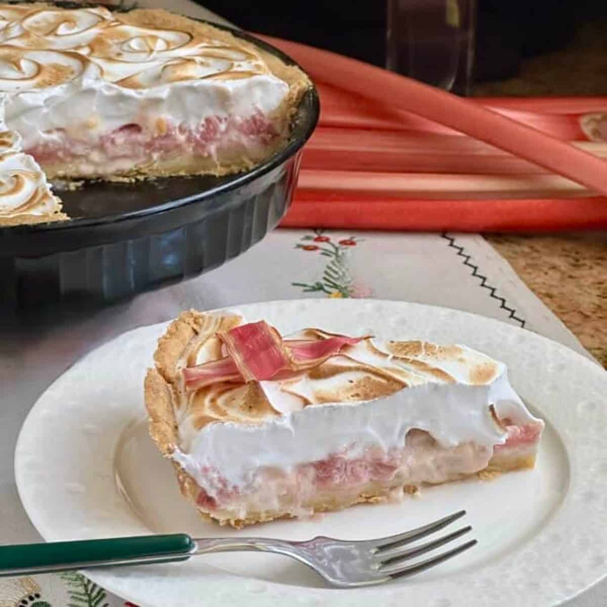 A slice of rhubarb tart on a white plate.