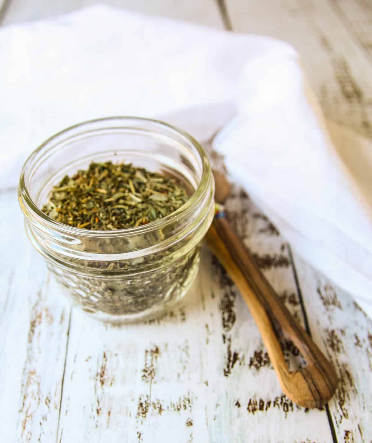 Italian seasoning in a small glass jar.