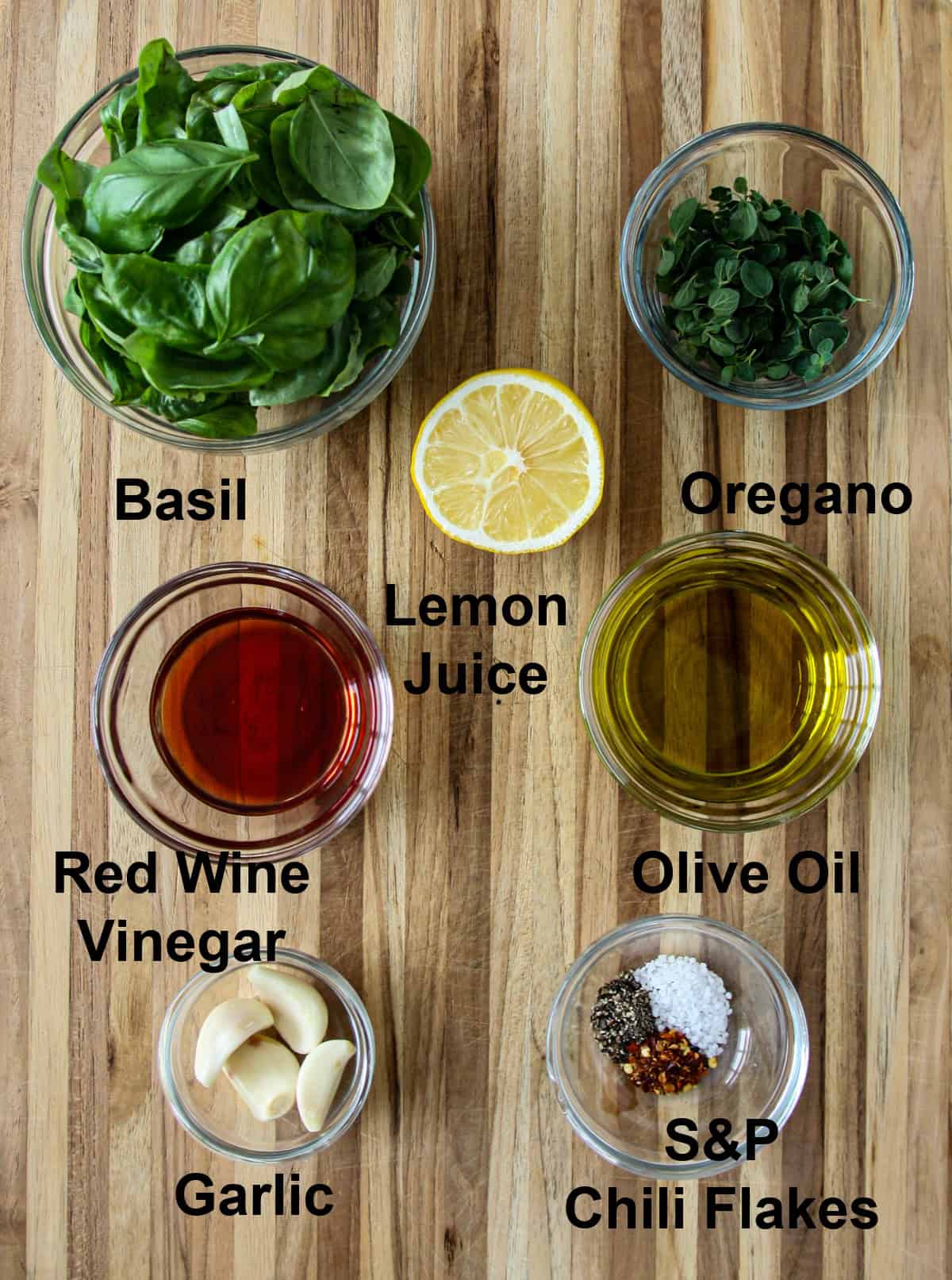 The ingredients for this recipe in glass bowls on a wooden board.